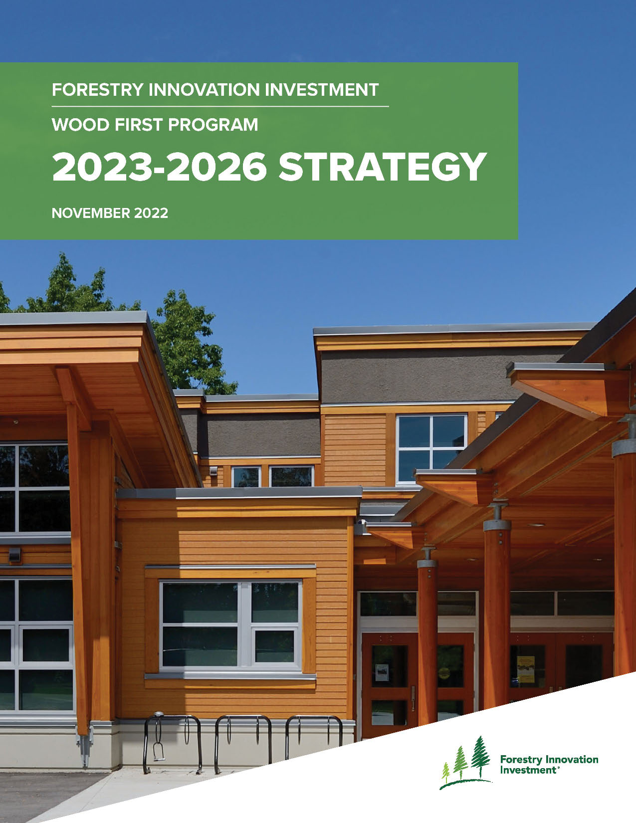 Cover page has photo of a low-rise mass timber building facade with clear blue sky. Green banner at the top reads: Forestry Innovation Investment. Wood First Program. 2023 to 2026 Strategy. Published November 2022.